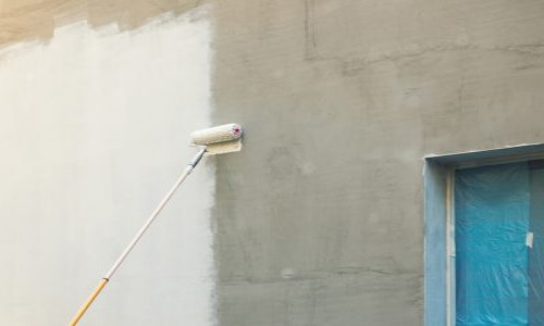 Primer being applied to stucco exterior