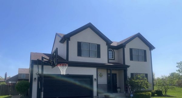 front of house with painted exterior, garage door and trim