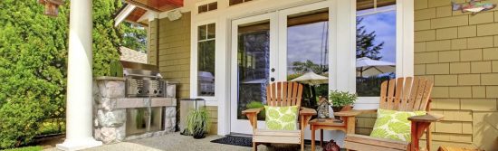 Stained wood deck with outdoor chairs and grill
