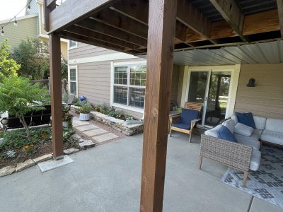 underside of stained wooden deck above patio