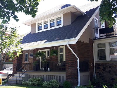 Historic Dundas red brick house featuring a freshly painted taupe upper gable, white soffits, and white window trim.
