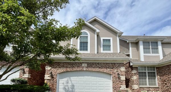 driveway view of home in hoa community