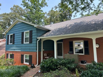 split level house with brick and blue painted siding