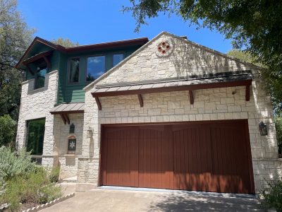 house exterior with green painted siding and washed limestone