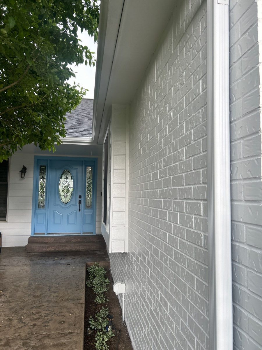 exterior of brick home painted white with blue front door Preview Image 3