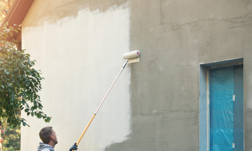 Man Roll Painting Stucco