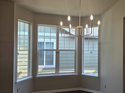 painted room with large windows and chandelier