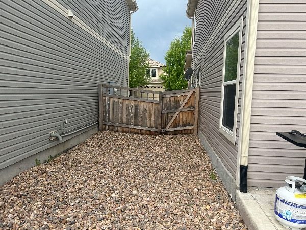 unstained fence surrounding home and yard Preview Image 9