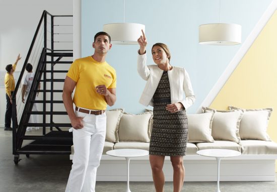 Women pointing at a wall with a Certapro Painter