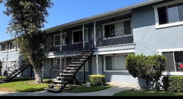painted light blue apartment building in Orange County, CA