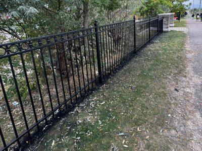 painted metal railing along length of sidewalk