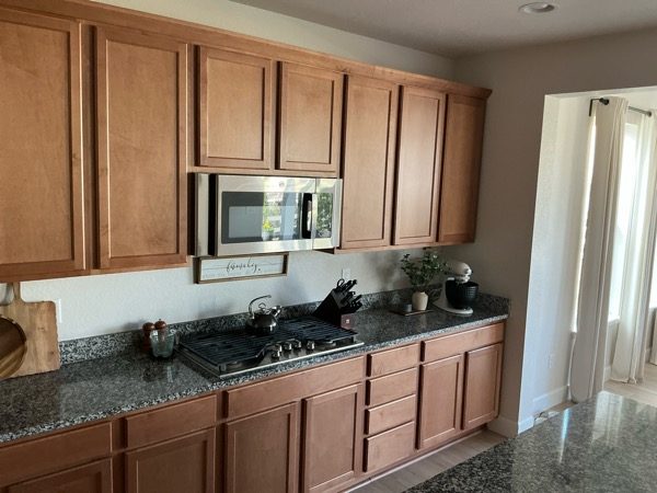 kitchen interior with stained wood cabinets and drawers Preview Image 5