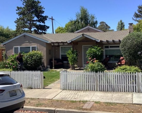Full home shot with white fence